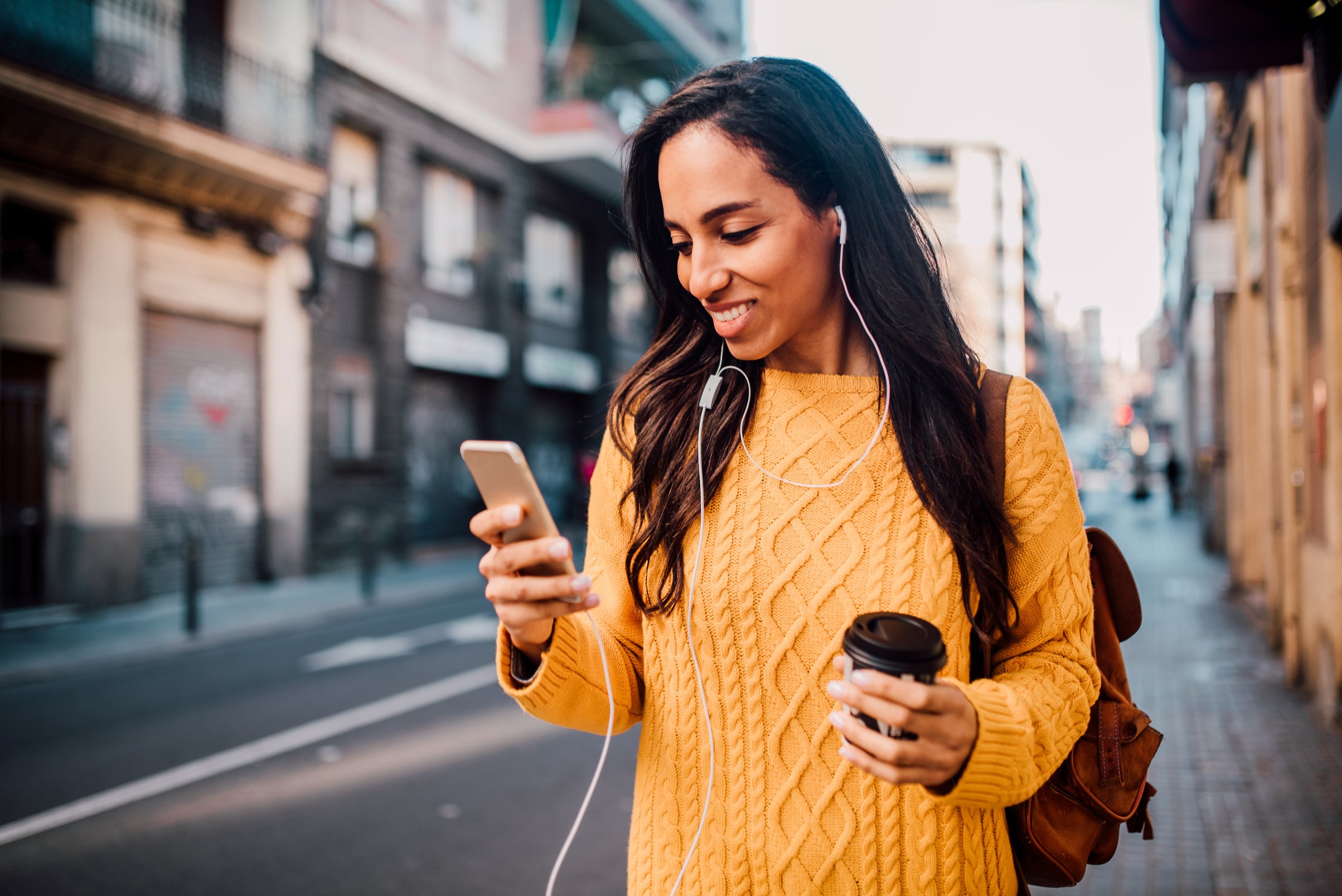 Happy woman looking at phone